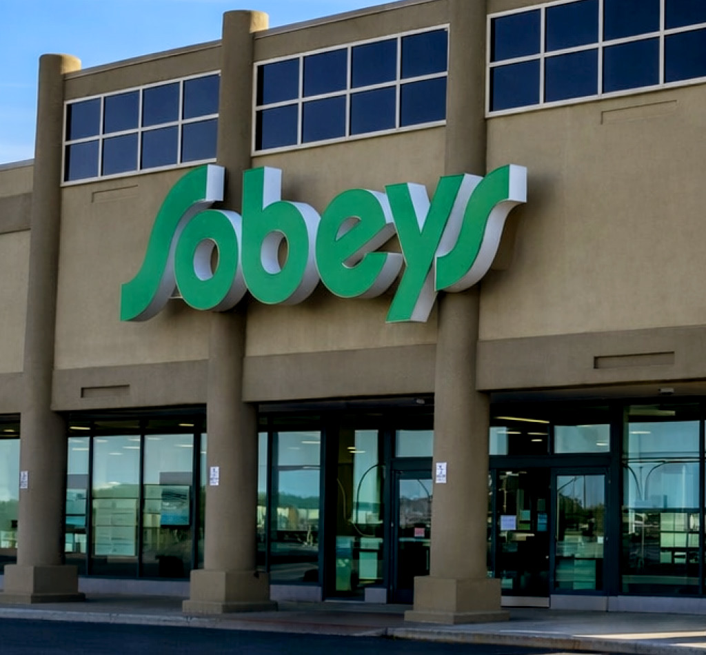 Exterior of a Sobeys grocery store; exterior of the office building at 145 Wellington Street West in Toronto, Ontario.
